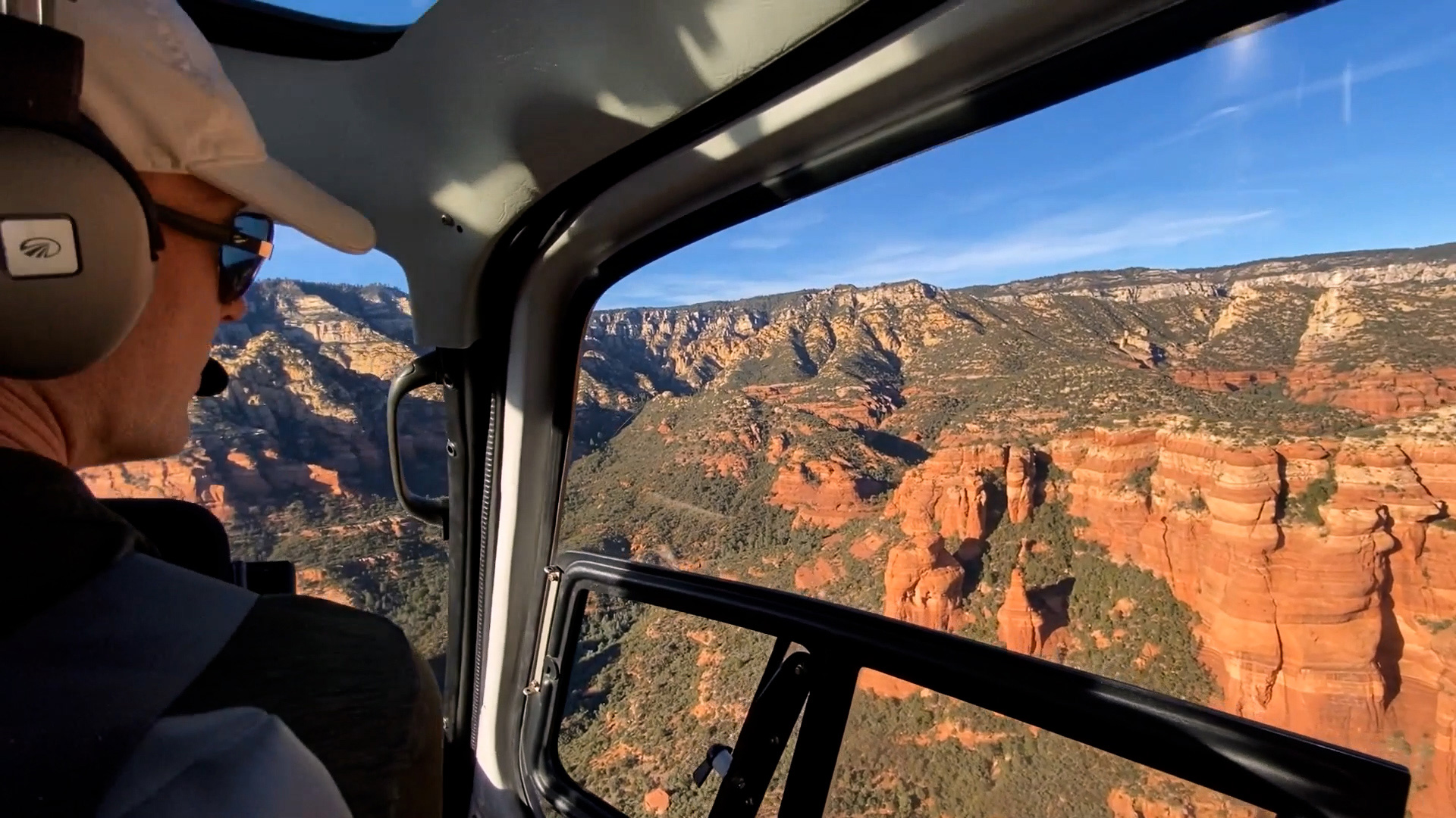 View from inside a helicopter flying over red rock canyons in Sedona