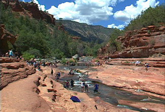 Families cooling off at the popular Slide Rock State Park in Oak Creek Canyon